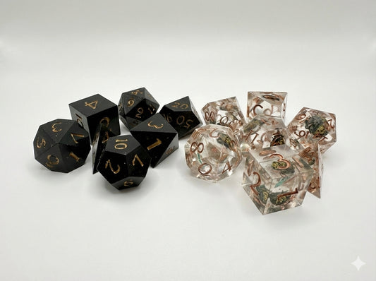 Black and clear dice with decorative patterns on a white background