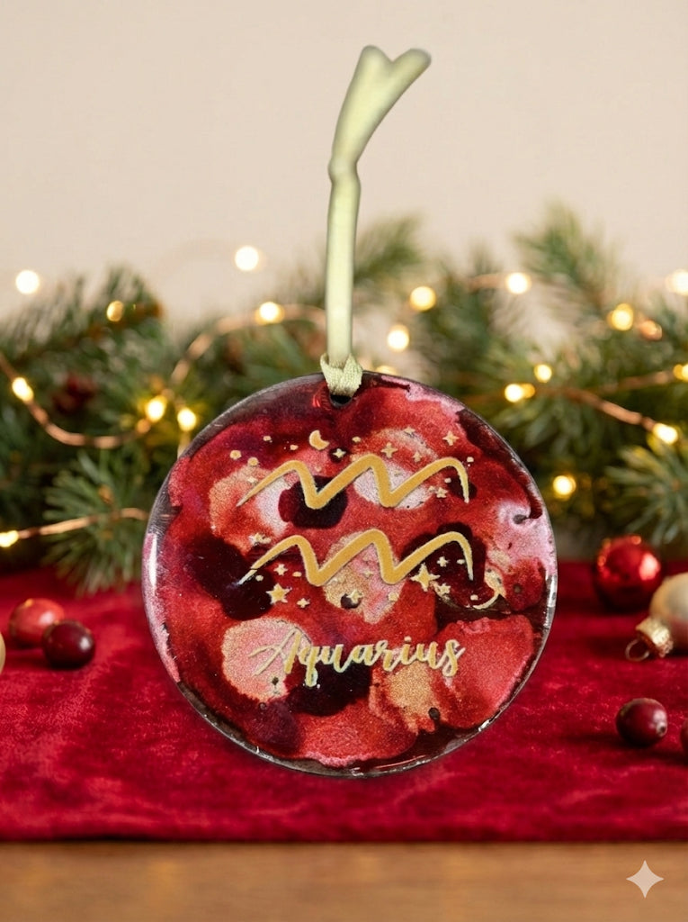 Decorative zodiac ornament for Aquarius on a festive background with lights and greenery.