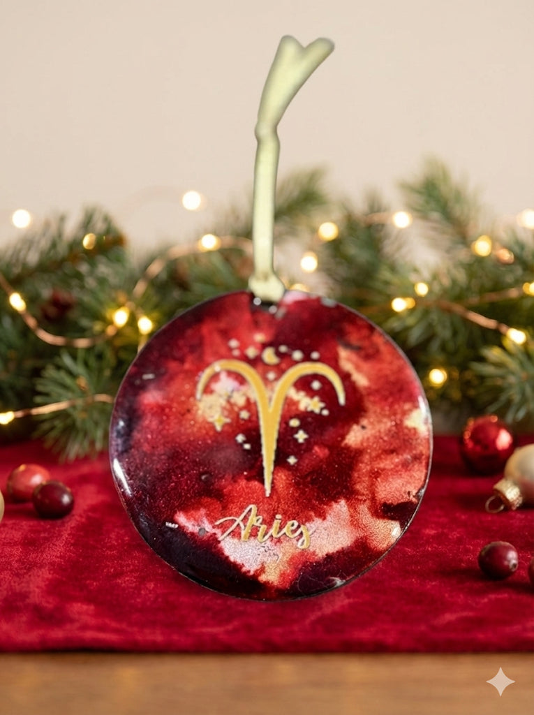 Decorative Christmas ornament with Aries symbol on a red background