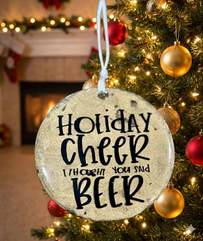 Decorative ornament with 'Holiday Cheer I Thought You Said Beer' text on a Christmas tree.