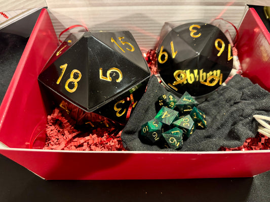 Black polyhedral dice with yellow numbers in a red box