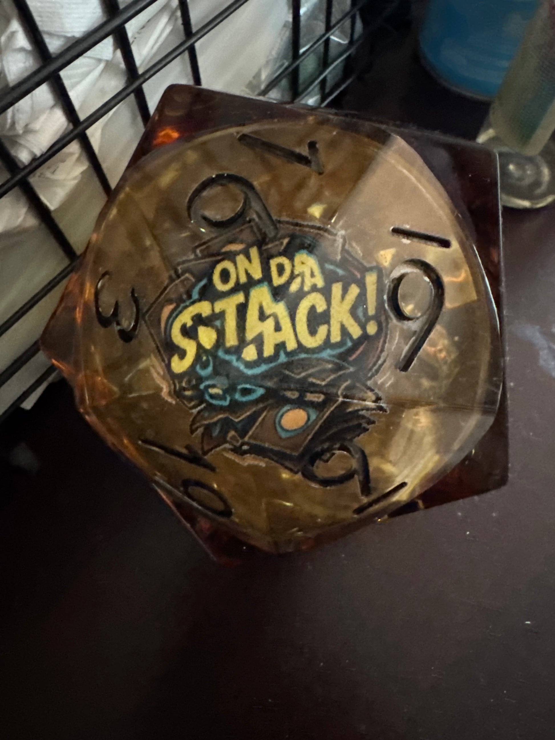 Translucent dice with 'On Da Stack' text and design on a dark background