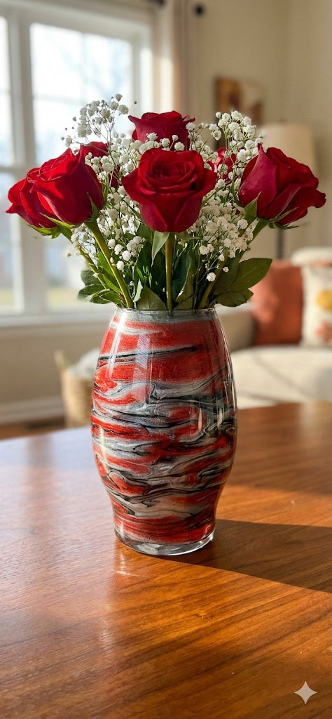 Vase with red roses and baby's breath on a wooden table